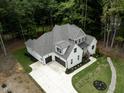 The house's two-car garage and circular driveway are visible in this aerial shot at 2410 Carpenter Pond Rd, Raleigh, NC 27613