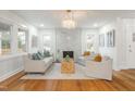 Bright living room featuring hardwood floors, a modern fireplace, and elegant decor for a cozy atmosphere at 2515 W Club Blvd, Durham, NC 27705