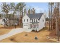 Charming two-story home with white siding, stone accents, and a welcoming front porch at 280 Scotland Dr, Youngsville, NC 27596