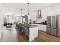 A modern open concept kitchen with stainless steel appliances and a center island with barstool seating at 2906 Kempthorne Rd # 54, Cary, NC 27519