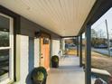 Covered front porch with seating, a welcoming entrance, and well-manicured landscaping at 301 W Hill S Ave, Hillsborough, NC 27278