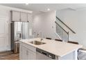 Bright kitchen with stainless steel appliances, white cabinets, and quartz countertops at 3019 Vitner Dr, Durham, NC 27704