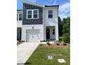 Inviting townhome boasts manicured lawn, modern design, and charming curb appeal at 3019 Vitner Dr, Durham, NC 27704