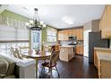 Open kitchen with wood cabinets, center island, and an adjacent breakfast area at 303 Shakespeare St, Morrisville, NC 27560
