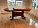 Sunlit dining room with hardwood floors, large windows, and an extendable wooden table at 3108 Fortress Gate Dr, Raleigh, NC 27614