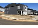 New construction home with gray siding and white trim, situated on a corner lot, two car garage at 4301 Darius Lane # 28, Fuquay Varina, NC 27526
