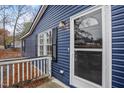 Up close image of the front of the house with blue siding and a white storm door at 453 Deer Vw, Sanford, NC 27332
