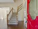 Bright foyer with hardwood floors, staircase, and a red front door with decorative glass at 4709 Wyndchase Ct, Fuquay Varina, NC 27526