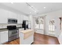 Well-lit kitchen featuring an island and stainless steel appliances at 5117 Singing Wind Dr, Raleigh, NC 27612