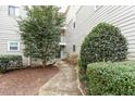 Inviting walkway lined with greenery leads to the condo's entrance at 600 Audubon Lake Dr # 5A32, Durham, NC 27713