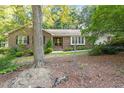 Lovely brick home with a beautiful front yard, mature tree, and a welcoming entrance at 6025 Spring Valley Dr, Raleigh, NC 27616