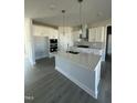 New kitchen features a central island, stainless hood, and stylish pendant lights at 622 Ravensworth Dr, Garner, NC 27529