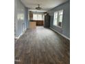 Spacious living room leading into kitchen with new flooring and abundant natural light at 728 East Ave, Henderson, NC 27536