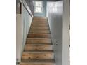 Wooden staircase featuring unfinished walls and a window at 728 East Ave, Henderson, NC 27536