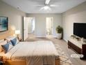 A spacious and well-lit bedroom with neutral tones and modern decor at 859 Dalewood Dr, Raleigh, NC 27610