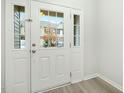 A bright entryway door with sidelights lets in natural light and offers a clear view of the exterior at 94 E Grove Point Dr, Clayton, NC 27527