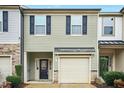 Well maintained townhome with black shutters, a garage, and tasteful landscaping at 94 E Grove Point Dr, Clayton, NC 27527