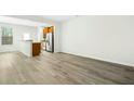 Spacious living room with plenty of natural light and durable wood-look floors at 94 E Grove Point Dr, Clayton, NC 27527