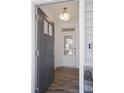 Open foyer view with wood floors, showcasing the front door with glass and lighting at 35 Merle Dr, Wendell, NC 27591