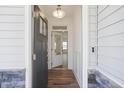 Bright foyer view showcasing wood floors, front door with glass, and modern lighting at 35 Merle Dr, Wendell, NC 27591