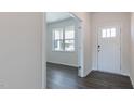 Inviting entryway featuring a white front door, hardwood floors, and a view into the adjacent living area at 100 Tobacco Woods Dr, Youngsville, NC 27596