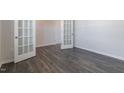 Spacious room featuring neutral walls, hard wood floors, and glass paneled doors at 100 Tobacco Woods Dr, Youngsville, NC 27596