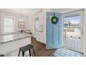 Bright kitchen featuring white cabinets, granite countertops, and a view to the front porch at 1012 Holloway St, Durham, NC 27701