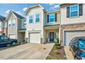 Charming townhome with a one-car garage, stone details, and covered front porch at 1019 Grand Ridge Dr, Rolesville, NC 27571