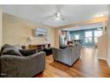 The living room features laminate floors, a ceiling fan and furniture at 1019 Grand Ridge Dr, Rolesville, NC 27571
