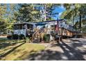 Charming exterior with deck and ramp, and an American flag on display at 104 Piquot Drive, Louisburg, NC 27549