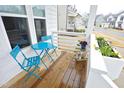 Cozy front porch with table and chairs, decorative flower pots, and wood-style flooring provides a peaceful retreat at 106 Cottage Way # 33, Pittsboro, NC 27312