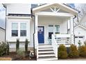 Inviting front porch of this home shows a blue front door, and white stairs that are well lit with natural light at 106 Cottage Way # 33, Pittsboro, NC 27312