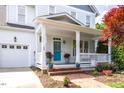 Inviting front porch with a brick walkway and a blue front door at 109 Parkridge Ave, Chapel Hill, NC 27517