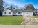 Charming single-story home with a lush green lawn and an attached single car garage at 1102 S 1St St, Lillington, NC 27546