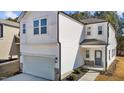 Bright two-story home featuring a white exterior, a gray front door, and an attached two-car garage at 1107 Depot Dr, Durham, NC 27703