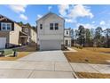 New construction home with a two-car garage, a concrete driveway and a well-maintained front lawn at 1107 Depot Dr, Durham, NC 27703