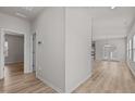 Inviting hallway with neutral walls and wood-look flooring, leading to a bright living area at 1107 Depot Dr, Durham, NC 27703