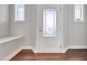 Bright entryway featuring decorative door glass, sidelight windows, and a convenient built-in bench at 1109 Hemby Ridge Ln, Morrisville, NC 27560