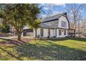 Exterior view of house featuring attached garage, with white siding and black trim, and an expansive lawn at 14115 Allison Dr, Raleigh, NC 27615