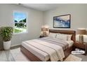A cozy bedroom featuring stylish decor, a soft rug, and natural light from the window at 1599 Rogers Pointe Ln, Creedmoor, NC 27522