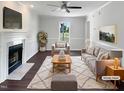 Bright, staged living room with a cozy fireplace, modern decor and plush rug at 1599 Rogers Pointe Ln, Creedmoor, NC 27522