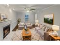 Bright living room featuring a fireplace, plush seating, and a stylish area rug at 1599 Rogers Pointe Ln, Creedmoor, NC 27522
