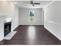 Bright living room with a cozy fireplace, fresh paint, and modern ceiling fan at 1599 Rogers Pointe Ln, Creedmoor, NC 27522