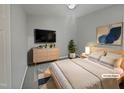 Comfortable main bedroom featuring a large bed, dresser and sleek TV at 1599 Rogers Pointe Ln, Creedmoor, NC 27522