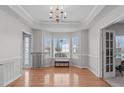 Bright dining room with hardwood floors, a bay window, and modern chandelier at 177 Clarence Ln, Garner, NC 27529