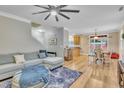 Open-concept living room with hardwood floors and a comfortable sectional sofa at 181 Steam Engine Way, Garner, NC 27529