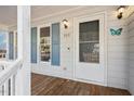Inviting entryway with a well-lit porch and charming details, creating a warm welcome at 209 Hutchins Dr, Garner, NC 27529