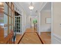 Bright foyer featuring hardwood floors with decorative inlay and views into other rooms of the home at 216 Copper Beech Ct, Chapel Hill, NC 27517