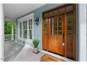 Close-up of a wood front door featuring sidelights, a transom window, and a 'Welcome' mat at the entrance at 216 Copper Beech Ct, Chapel Hill, NC 27517