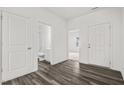 Open entryway featuring wood-look flooring, white doors, and access to the bathroom at 260 Logan Creek Dr, Zebulon, NC 27597